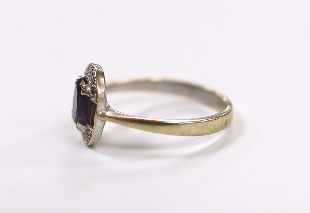 A modern Art Deco style 9ct white gold, amethyst and diamond chip set cluster ring, size Q/R, gross weight 3 grams.